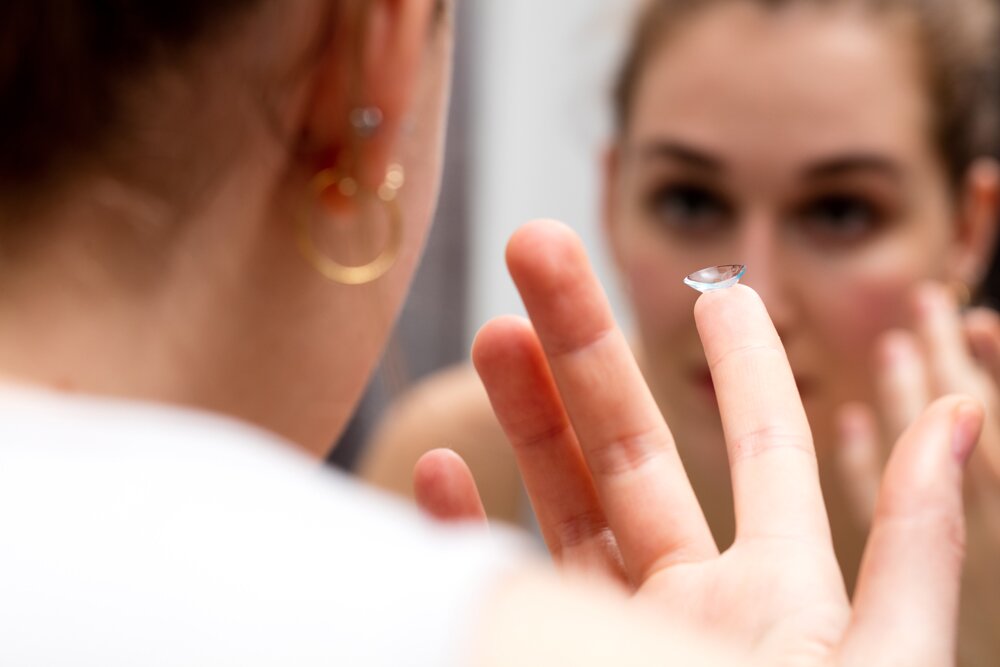 woman applying contact lens